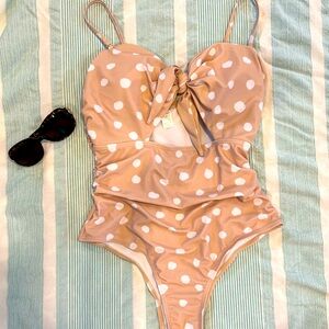 Tan and white polka dot one piece.